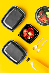 Tomatoes salad in plastic delivery tray, top view. Catering concept