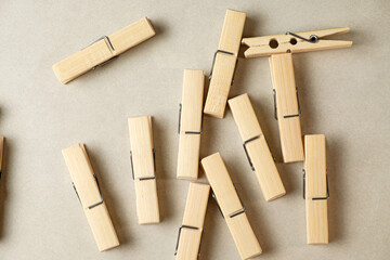 Delicate wooden clothespins scattered on a soft, textured surface