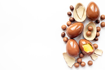 A pile of chocolate eggs and candies, top view. Chocolate background