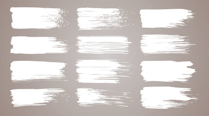 Vector paint brush set. White ink grunge brush strokes. Grunge design elements. Painted ink stripes. Creative isolated spots. Ink smudge, abstract shape stains and smear set