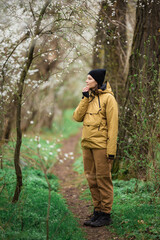 Obraz premium A girl walking through nature and enjoying the beautiful and blooming spring.