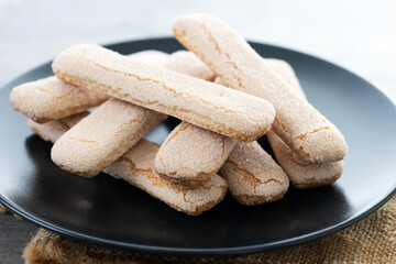 Italian biscuits ladyfingers savoiardi on wooden table