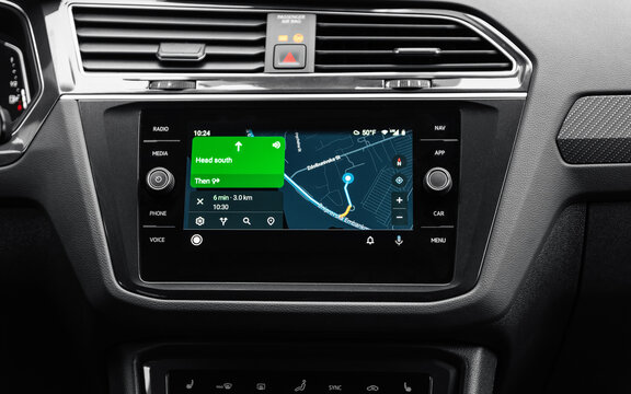 Google maps navigation on screen in modern car. Volkswagen car interior - close-up shot of infotainment system with Android auto screencast. Kyiv, Ukraine - September 20 2021.