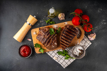 Grilled beef steak on wooden cutting board