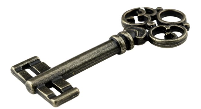 Close up shot of an antique metal key with a decorative head on a black background in studio lighting