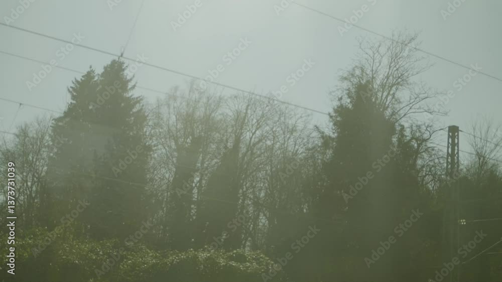 Poster inside an ice high-speed train, showing blurry view through the window and power lines