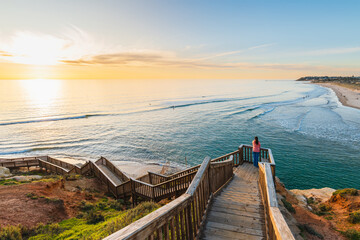 Woman enjoying spectacular view from the South Port Beach boardwalk during sunset, Port Noarlunga, South Australia