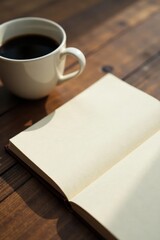 Morning coffee and an open notebook awaiting inspiration on a wooden table