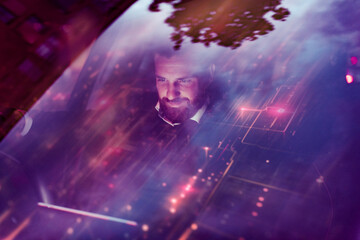 Man using augmented reality technology in a car at night