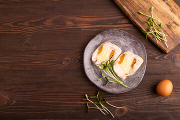 Chicken, egg and dried apricot meatloaf, microgreen on brown wooden. Diet, healthy eating. top...