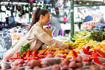 Woman shopping for fresh produce at a local outdoor market
