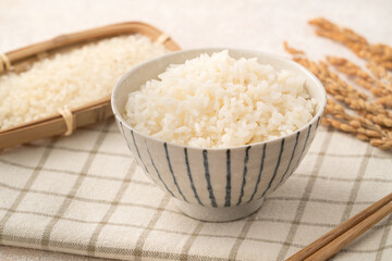 A cookd steamed white rice in a Traditional bowl.
