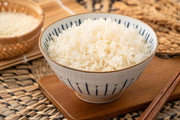 A cookd steamed white rice in a Traditional bowl.