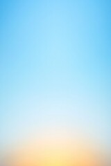 Soft gradient sky transitions from blue to warm orange, evoking