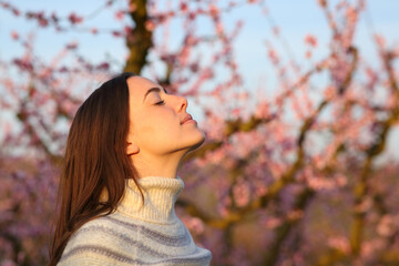 Woman at sunset in winter breathing fresh air