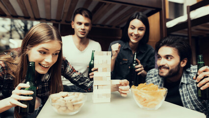 Friends portrait playing in Jenga Together.