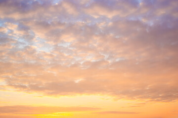 Beautiful sky with clumps of clouds at sunset, soft pink-orange colors. Heavenly landscape