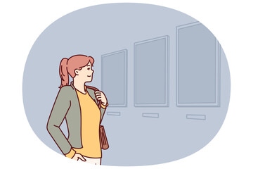 Woman visiting art gallery looks at paintings hanging on wall, painted by classical or contemporary artists. Young girl is in art exhibition hall contemplating work of famous painters.