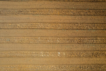 Rows of soil before planting. Furrows row pattern in a plowed field prepared for planting crops in spring. view of land prepared for planting and cultivating the crop.