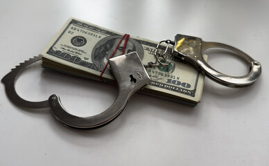 many dollar bills with handcuffs