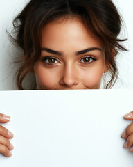Smiling woman peeking over blank sign