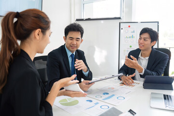 Team Collaboration and Business Strategy. A group discussing data-driven decisions in a modern office.