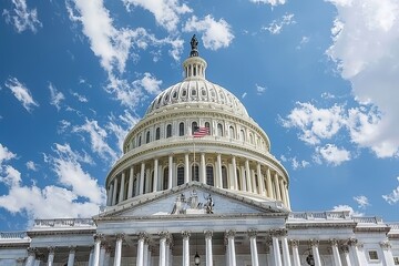 Fototapeta premium Close up view of the white dome of the capitol surrounded by a bright blue sky and american flag