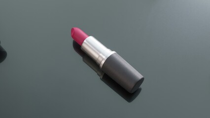 Luxurious pink lipstick gliding within sleek gray tube, spinning gracefully on reflective surface, revealing rich color and elegant design against pristine background