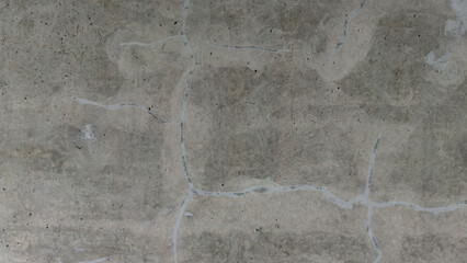 Close-up of a Textured Concrete Surface Showing Cracks and Imperfections in a Natural Gray Background