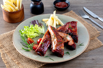 Delicious barbecued ribs seasoned with a spicy basting sauce and served with baked tomatoes