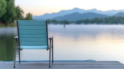 Serene lakeside view with solitary chair overlooking calm waters