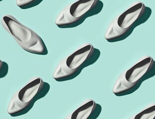 Obraz premium Arrangement of Stylish Silver Ballet Flats on Light Blue Background Pattern