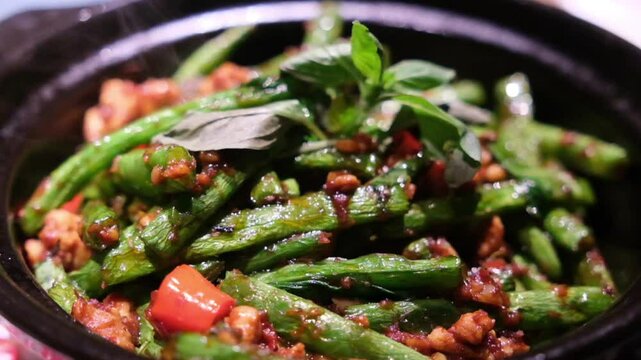 Slow motion of green beans with Belacan. Thai food.