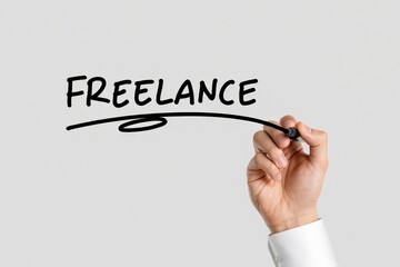 Businessman hand writing freelance on gray background. Freelance job or working as a freelancer.
