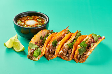 Traditional mexican birria consome soup and four taco with stewed beef