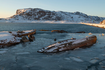 Sunny March morning on the cemetery of old ships. Teriberka, Murmansk region. Russia