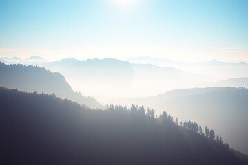 Naklejka premium Majestic mountains shrouded in mist during early morning light in a serene landscape
