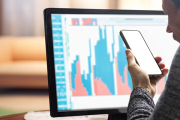 Stressed frustrated broker making wrong investment and screaming while talking on smartphone. Young...