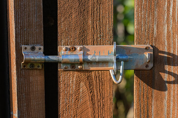 Rusty Metal Latch on a Wooden Garden Gate.