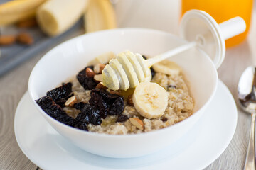 Energy breakfast with oatmeal, honey and dried fruits
