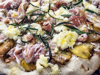 Deliciously crafted pizza topped with fresh ingredients in a cozy kitchen setting during afternoon...