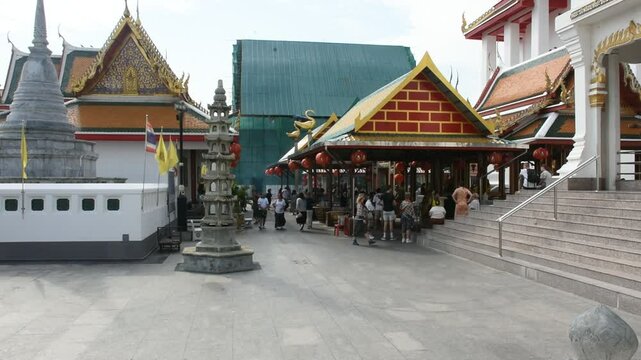 Travelers thai people travel visit ancient building of Wat Kalayanamit Temple and respect praying blessing wish holy antique buddha statue mystery deity angel god on March 9, 2025 in Bangkok, Thailand