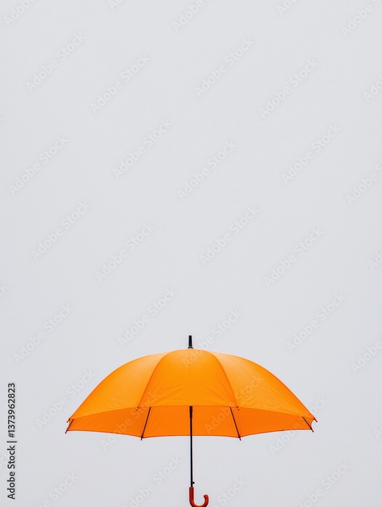 Poster the image is of an orange umbrella with a black handle. the umbrella is open and the canopy is sligh
