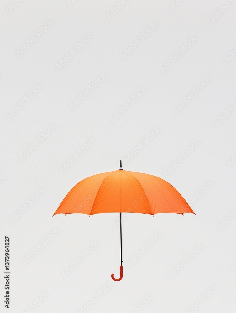 Poster the image is of an orange umbrella with a black handle. the umbrella is open and appears to be float