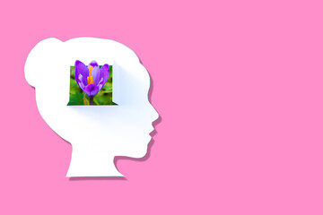 Paper Cutout Of Woman's Head With Flower Growing From Her Mind on Pink