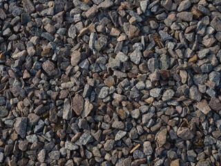 Close-up top view of detailed texture gravel and crushed stones, natural patterns backgrounds.