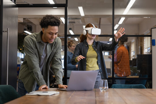 Young woman using virtual reality in an office meeting room