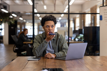 Young Man in Office Using Voice Command on Phone