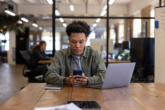 Young employee using AI on a smartphone to work efficiently
