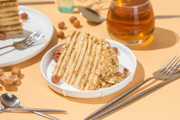 A piece of cake on a plate. Honey cake